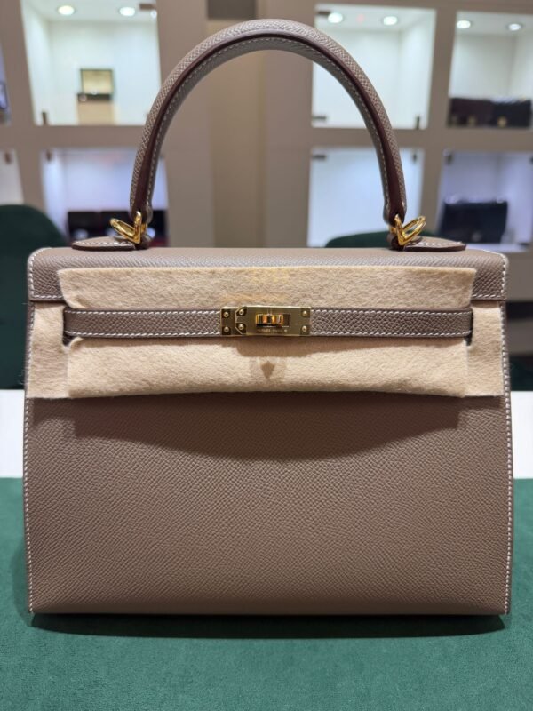 Herm&egrave;s Kelly 25 Sellier Nuova 2026 stampa G in pelle Epsom colore Etoupe con hardware dorato con tutti gli adesivi di protezione dell&rsquo;imballaggio e dell&rsquo;hardware.